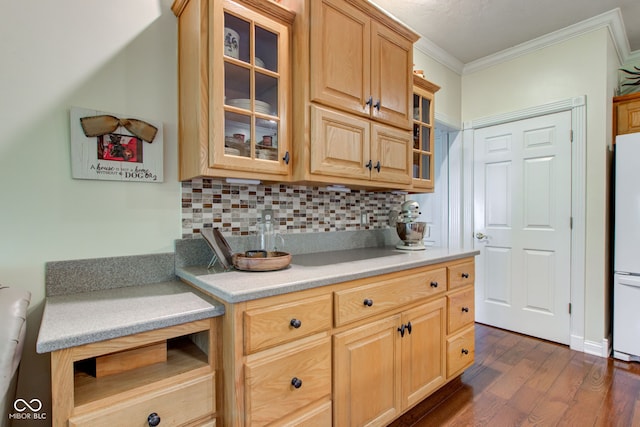 3533 Alexandria Pike, Anderson, IN 46012 - kitchen with ornamental molding, dark wood-style flooring, freestanding refrigerator, light countertops, and backsplash