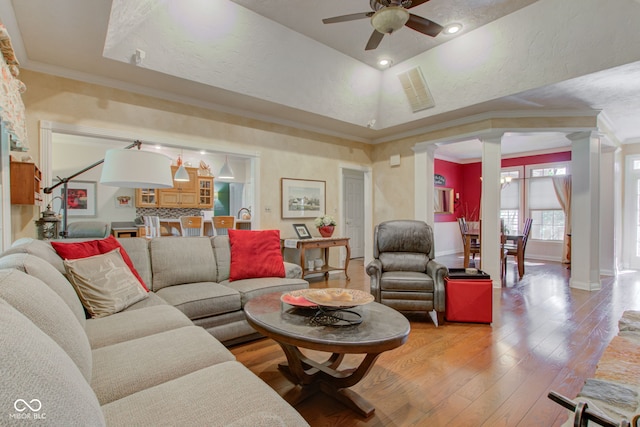 3533 Alexandria Pike, Anderson, IN 46012 - living room with ornate columns, a tray ceiling, light wood-style flooring, a ceiling fan, and ornamental molding