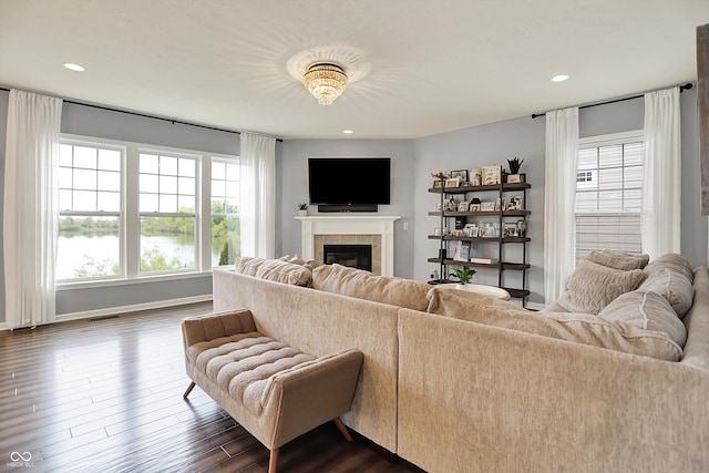 1071 Serenity Ct, Carmel, IN 46280 - living room featuring plenty of natural light, a tiled fireplace, dark wood-style floors, baseboards, and recessed lighting