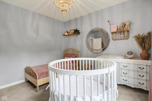 1071 Serenity Ct, Carmel, IN 46280 - carpeted bedroom with a chandelier, baseboards, and a nursery area