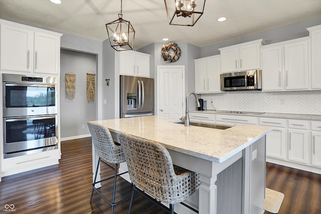 1071 Serenity Ct, Carmel, IN 46280 - kitchen with appliances with stainless steel finishes, a chandelier, a sink, backsplash, and recessed lighting