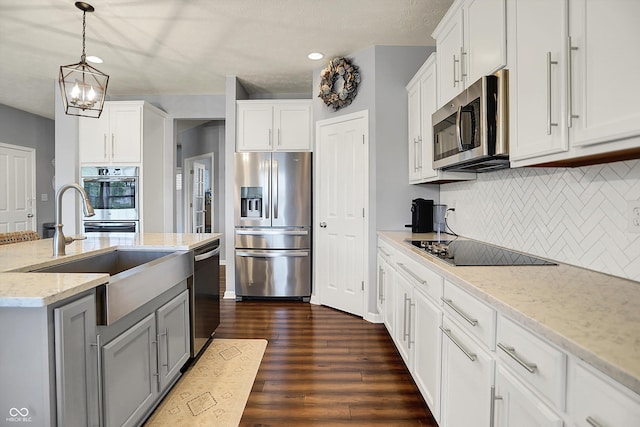 1071 Serenity Ct, Carmel, IN 46280 - kitchen with stainless steel appliances, a sink, dark wood-type flooring, decorative backsplash, and white cabinetry