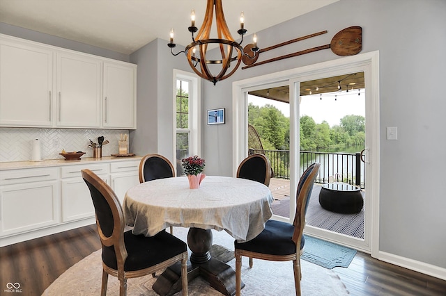 1071 Serenity Ct, Carmel, IN 46280 - dining area featuring a chandelier, dark wood finished floors, and baseboards