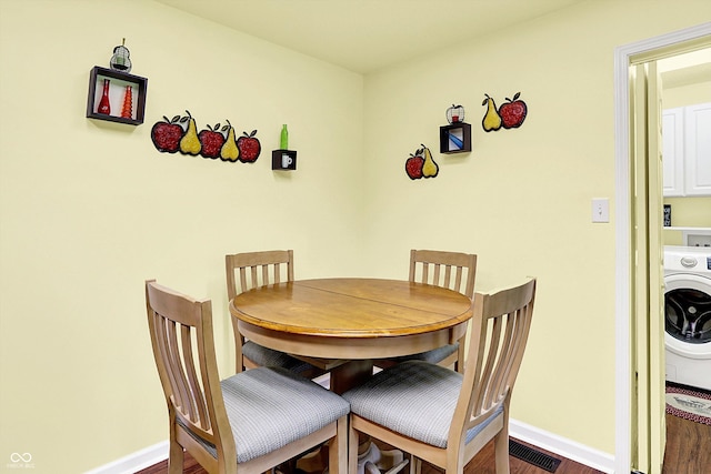 4125 S Post Rd, Indianapolis, IN 46239 - dining space with washer / clothes dryer, baseboards, and dark wood-style flooring