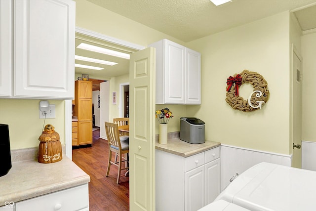 4125 S Post Rd, Indianapolis, IN 46239 - kitchen featuring dark wood-style floors, white cabinets, a wainscoted wall, and light countertops