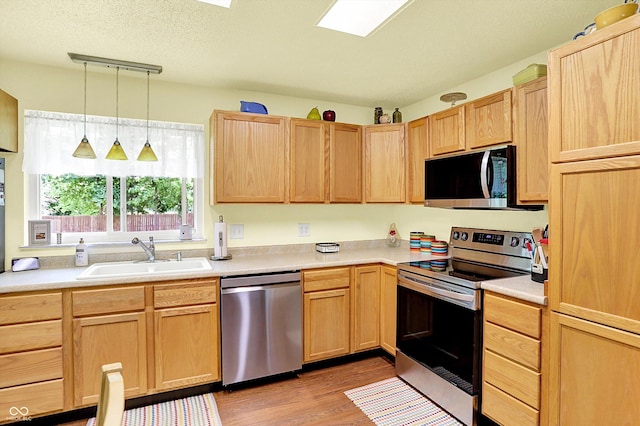 4125 S Post Rd, Indianapolis, IN 46239 - kitchen with appliances with stainless steel finishes, a sink, light brown cabinets, and light wood-style floors