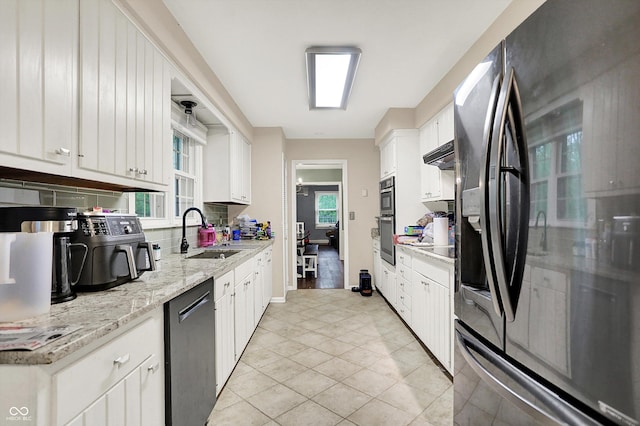 8301 E County Road 801 S, Plainfield, IN 46168 - kitchen featuring a sink, stainless steel appliances, white cabinetry, light tile patterned flooring, and light stone counters