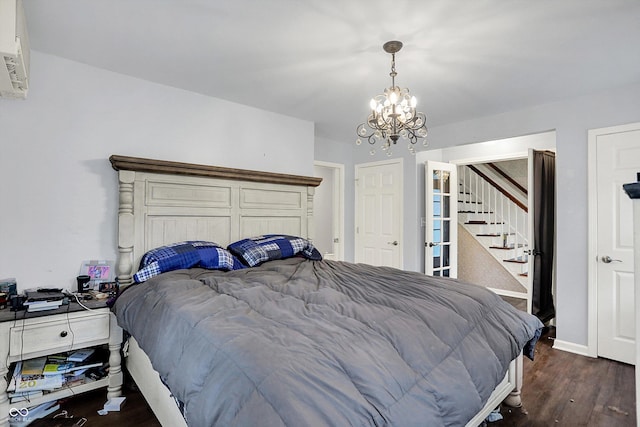 8301 E County Road 801 S, Plainfield, IN 46168 - bedroom with a chandelier, wood finished floors, an AC wall unit, and baseboards
