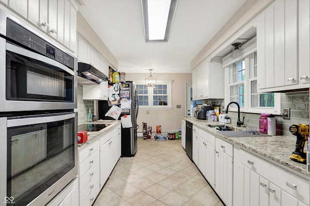 8301 E County Road 801 S, Plainfield, IN 46168 - kitchen with stainless steel appliances, under cabinet range hood, tasteful backsplash, and white cabinetry