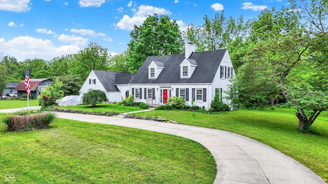 8301 E County Road 801 S, Plainfield, IN 46168 - cape cod home featuring a front lawn, curved driveway, a chimney, and view of scattered trees