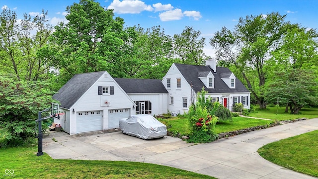 8301 E County Road 801 S, Plainfield, IN 46168 - cape cod house with a front lawn, a chimney, concrete driveway, and view of wooded area