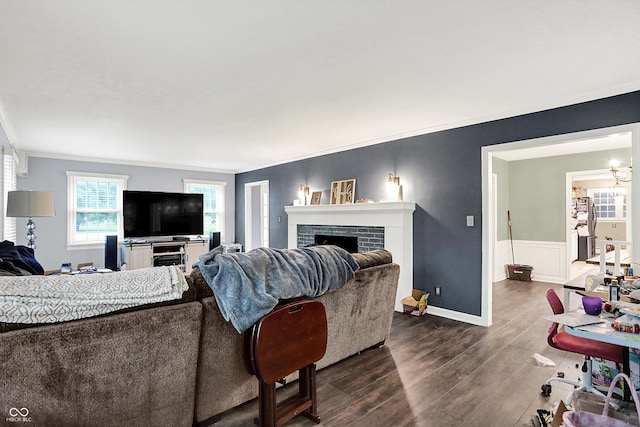 8301 E County Road 801 S, Plainfield, IN 46168 - living area with dark wood finished floors, a brick fireplace, ornamental molding, wainscoting, and baseboards