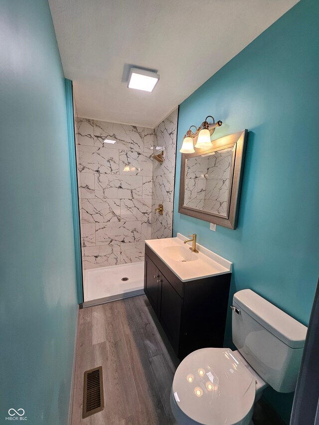 1644 Dr Andrew J Brown Ave, Indianapolis, IN 46202 - full bath featuring vanity, toilet, a marble finish shower, and wood finished floors