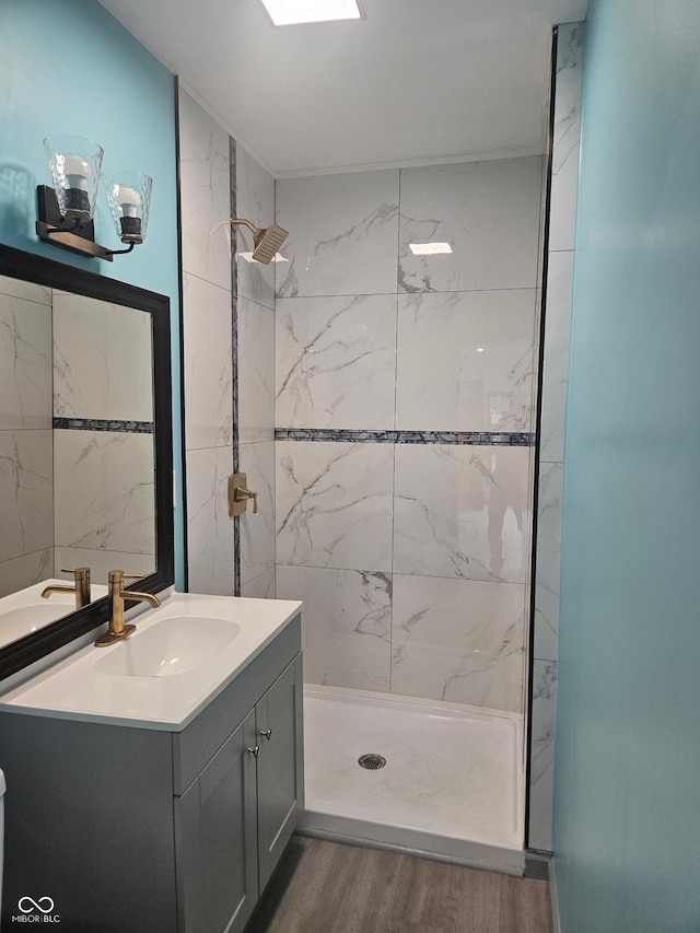 1644 Dr Andrew J Brown Ave, Indianapolis, IN 46202 - bathroom with wood finished floors, vanity, and tiled shower