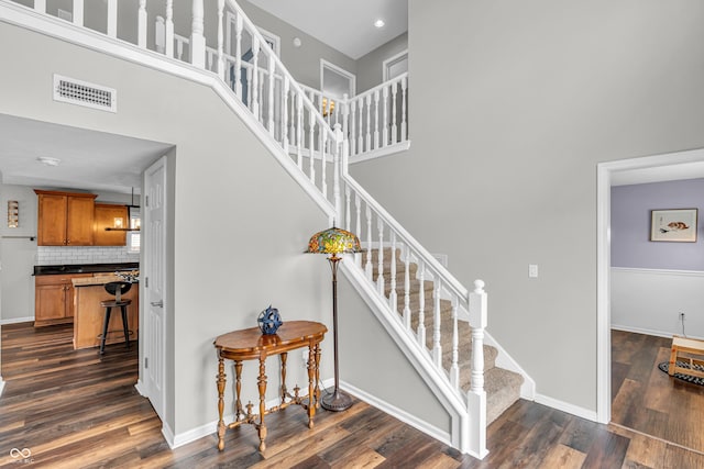 9754 Bradford Knoll Dr, Fishers, IN 46037 - stairway featuring a towering ceiling, wood finished floors, and baseboards