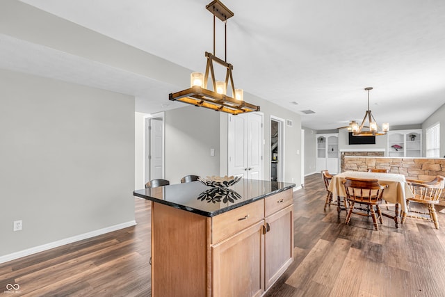 9754 Bradford Knoll Dr, Fishers, IN 46037 - kitchen featuring a chandelier, dark wood-type flooring, open floor plan, a kitchen island, and pendant lighting