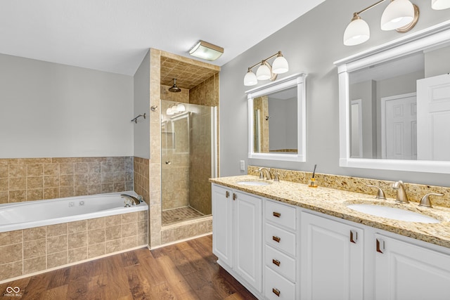 9754 Bradford Knoll Dr, Fishers, IN 46037 - full bath with a shower stall, double vanity, a garden tub, and wood finished floors