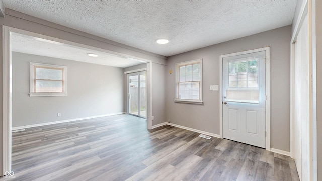 5806 E 19th St, Indianapolis, IN 46218 - entryway featuring wood finished floors, a textured ceiling, and baseboards