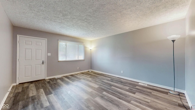 5806 E 19th St, Indianapolis, IN 46218 - unfurnished room featuring wood finished floors, baseboards, and a textured ceiling
