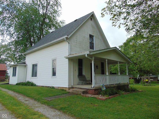 205 W S St, Darlington, IN 47940 - view of front of home with covered porch, a front yard, and a shingled roof