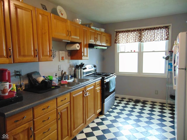205 W S St, Darlington, IN 47940 - kitchen featuring stainless steel range with electric stovetop, a sink, light floors, freestanding refrigerator, and under cabinet range hood