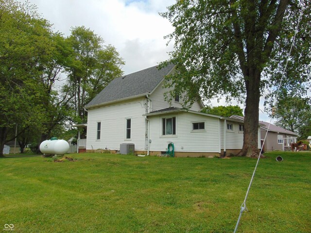 205 W S St, Darlington, IN 47940 - back of property featuring central AC unit, a lawn, and a shingled roof