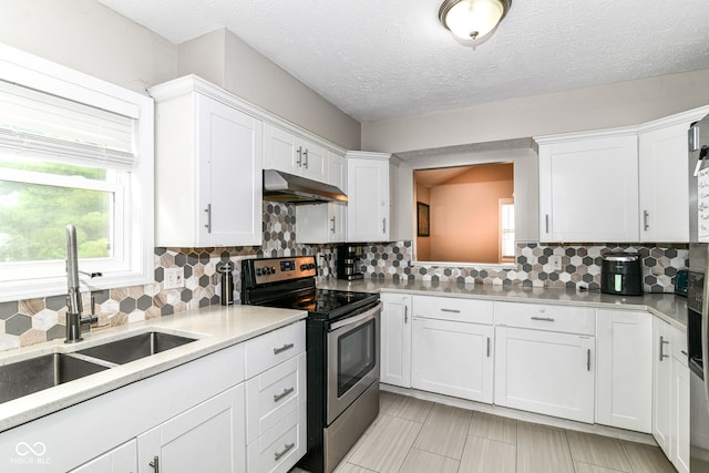 11612 E 75th St, Indianapolis, IN 46236 - kitchen with stainless steel range with electric cooktop, under cabinet range hood, a sink, light countertops, and white cabinetry