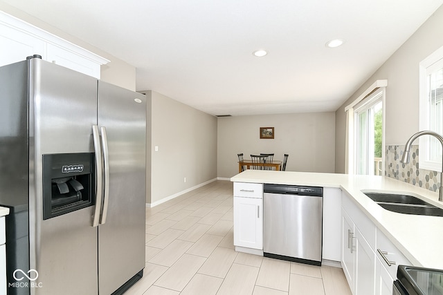 11612 E 75th St, Indianapolis, IN 46236 - kitchen with appliances with stainless steel finishes, a sink, a peninsula, light countertops, and white cabinets