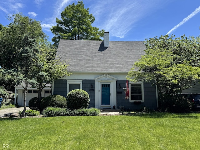 5889 Crestview Ave, Indianapolis, IN 46220 - cape cod-style house with a chimney, a front yard, an attached garage, and a shingled roof