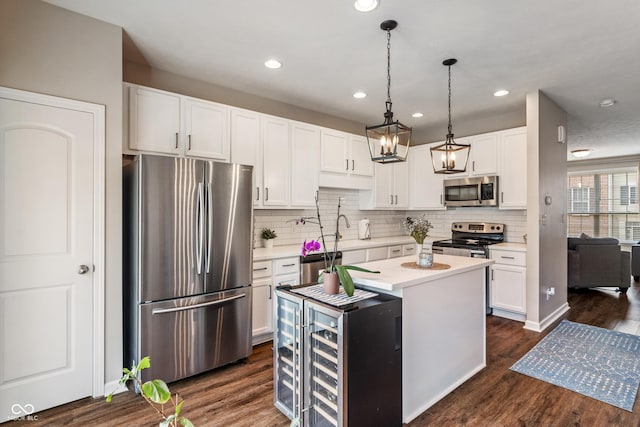 9090 Demarest Dr, Fishers, IN 46038 - kitchen with appliances with stainless steel finishes, beverage cooler, light countertops, white cabinetry, and recessed lighting