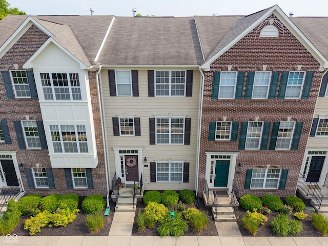 9090 Demarest Dr, Fishers, IN 46038 - townhome / multi-family property with brick siding and a shingled roof