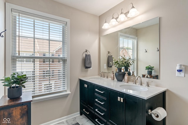 9090 Demarest Dr, Fishers, IN 46038 - bathroom with double vanity, marble finish flooring, and baseboards