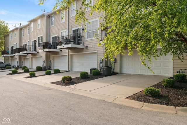 9090 Demarest Dr, Fishers, IN 46038 - view of front of home featuring concrete driveway, cooling unit, and a garage