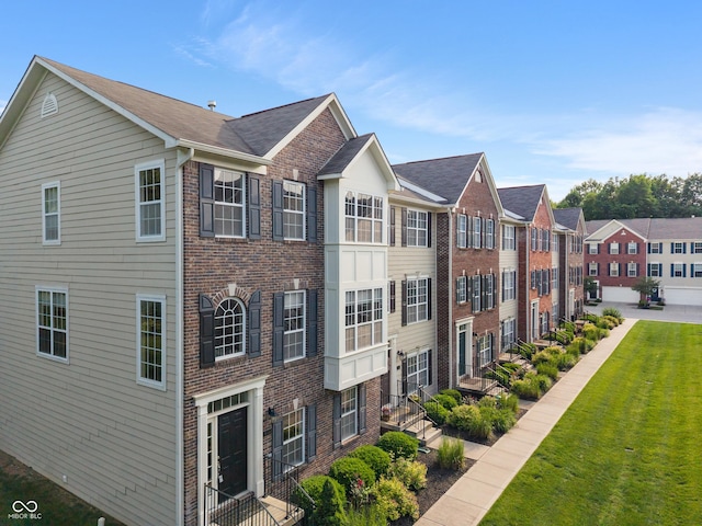 9090 Demarest Dr, Fishers, IN 46038 - view of home's exterior with brick siding and a lawn