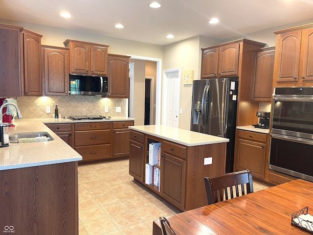 5010 Cabrillo Dr, Plainfield, IN 46168 - kitchen featuring appliances with stainless steel finishes, a sink, backsplash, recessed lighting, and a kitchen island