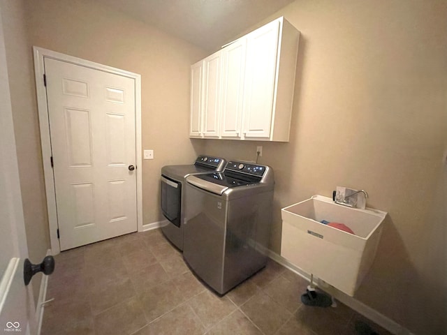 5010 Cabrillo Dr, Plainfield, IN 46168 - laundry area with washing machine and clothes dryer, cabinet space, baseboards, and light tile patterned floors