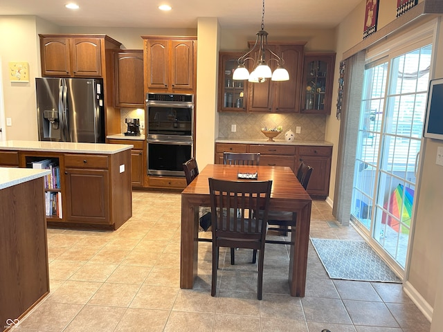 5010 Cabrillo Dr, Plainfield, IN 46168 - kitchen featuring appliances with stainless steel finishes, light countertops, tasteful backsplash, glass insert cabinets, and recessed lighting