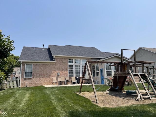 5010 Cabrillo Dr, Plainfield, IN 46168 - back of house featuring a playground, brick siding, a shingled roof, and a patio area