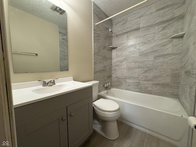 7929 Roy Rd, Indianapolis, IN 46219 - full bath with a textured ceiling,  shower combination, toilet, vanity, and wood finished floors