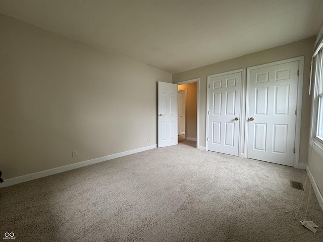 7929 Roy Rd, Indianapolis, IN 46219 - unfurnished bedroom with carpet, baseboards, and a closet