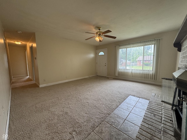 7929 Roy Rd, Indianapolis, IN 46219 - unfurnished living room featuring ceiling fan, carpet floors, baseboards, and tile patterned floors