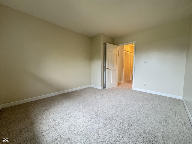 7929 Roy Rd, Indianapolis, IN 46219 - unfurnished bedroom featuring baseboards and carpet
