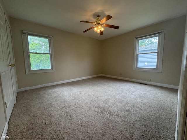 7929 Roy Rd, Indianapolis, IN 46219 - unfurnished room featuring baseboards, a ceiling fan, and carpet floors