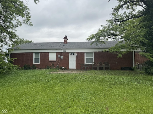 7929 Roy Rd, Indianapolis, IN 46219 - back of house featuring a lawn, brick siding, and a chimney