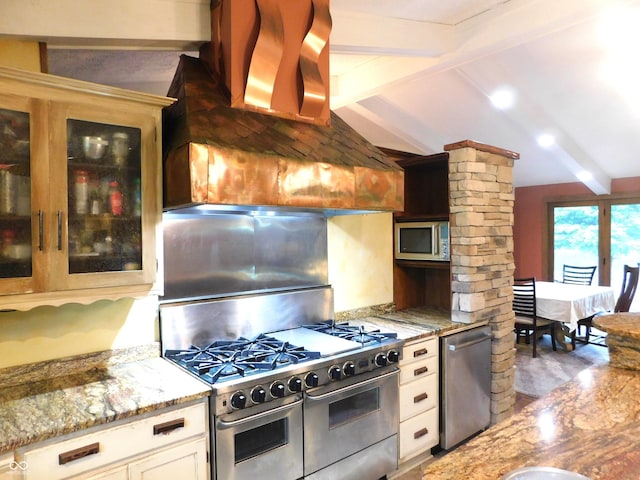 681 S County Road 150 W, Greensburg, IN 47240 - kitchen with stainless steel appliances, ornate columns, light stone countertops, glass insert cabinets, and custom range hood