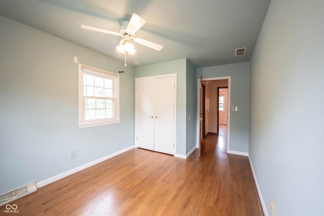 10244 Washington Blvd, Carmel, IN 46280 - unfurnished bedroom featuring wood finished floors, baseboards, a closet, and a ceiling fan