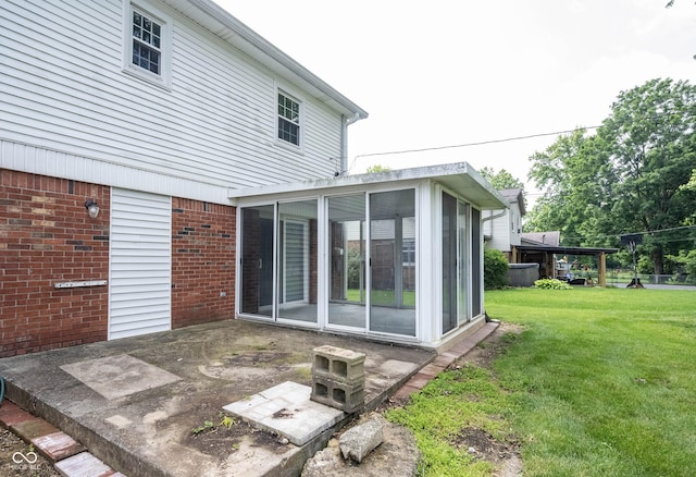 10244 Washington Blvd, Carmel, IN 46280 - rear view of house featuring a sunroom, brick siding, and a yard