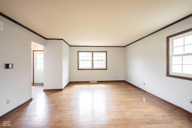 10244 Washington Blvd, Carmel, IN 46280 - spare room featuring healthy amount of natural light, light wood finished floors, crown molding, and baseboards