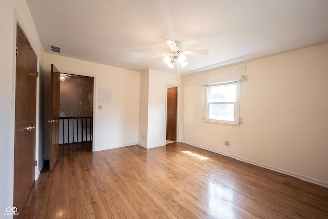 10244 Washington Blvd, Carmel, IN 46280 - unfurnished bedroom with wood finished floors, baseboards, and ceiling fan