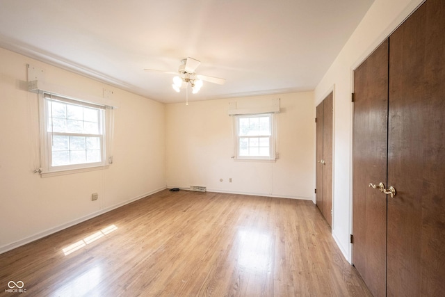 10244 Washington Blvd, Carmel, IN 46280 - unfurnished bedroom with light wood-style flooring, baseboards, a closet, and a ceiling fan
